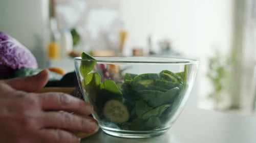 Salad Preparation with Spinach, Cucumber, and Tomatoes