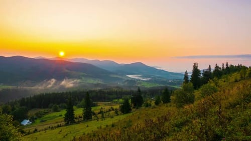 Fantastic Sunrise over the Foggy Summer Mountain