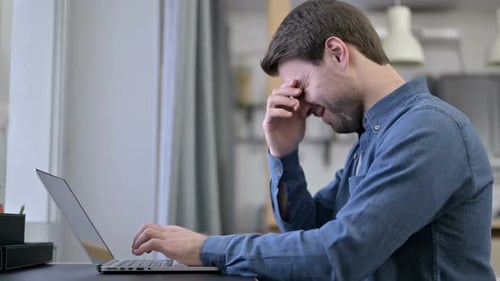 Beard Young Man Having Headache on Laptop