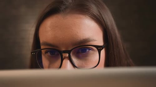 Woman with Glasses Looking at Screen Close Up