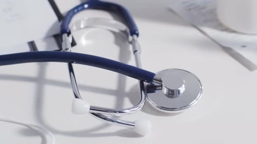 Close-up of different stuff and equipment on doctor's table in medical office in hospital.