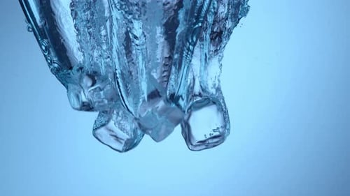 Ice Cubes Dropped into Clear Water
