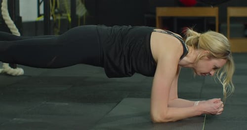 Fitness Woman Doing Plank Exercise Workout in Gym