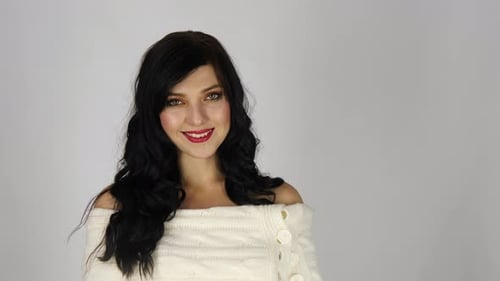 Woman with Black Hair Smiling in Studio Setting