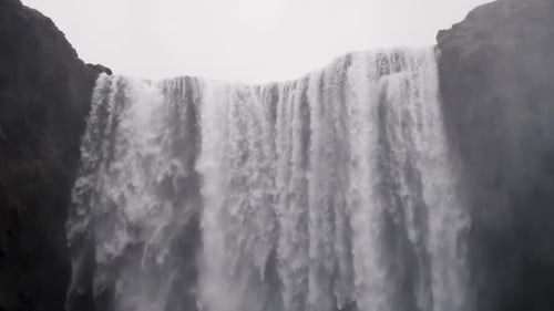 Powerful Waterfall Cascading Down Rocky Cliff