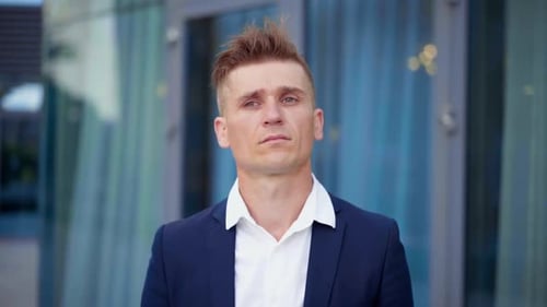 Young Man Rubbing Temples with Headache Outdoors