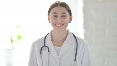 Young Doctor Smiles in Bright Hospital Setting