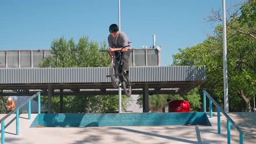 Male Biker Performing Trick in Urban Skatepark