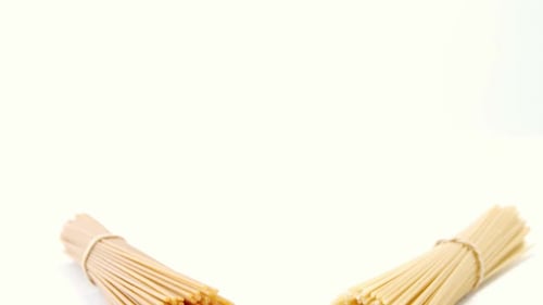 Bundles of Uncooked Spaghetti on White Background
