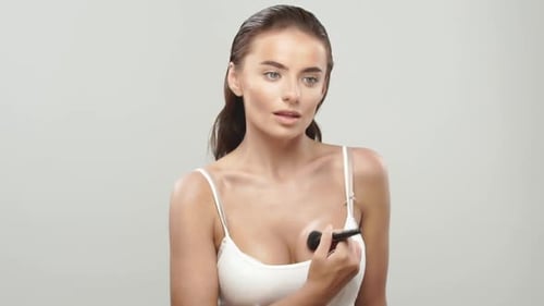 Pretty Woman Doing Makeup for Her Boobs