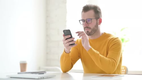 Man Receives Good News on his Mobile Phone