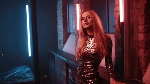 Woman Singer with Bright Makeup Sings a Song in the Studio for a Music Video