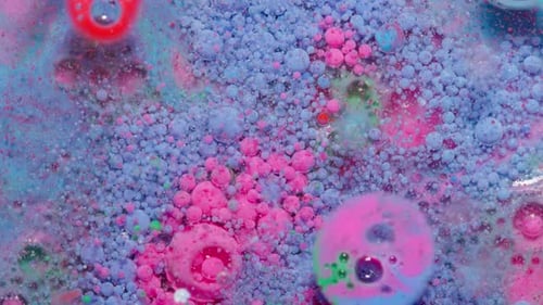 Top View Movement of Blue Pink Oil Ink Drops Bubbles Multicolored Artistic Paint Surface Background
