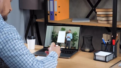 Man Student Study at Home Office Online Video Call Laptop Writes in Notebook