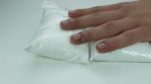 Hands Place Money and White Powder on Table