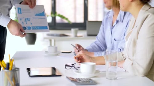 Business Team Discussing Charts at Office