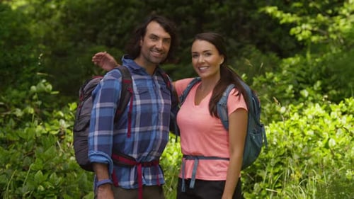 Couple Posing in Forest with Backpacks