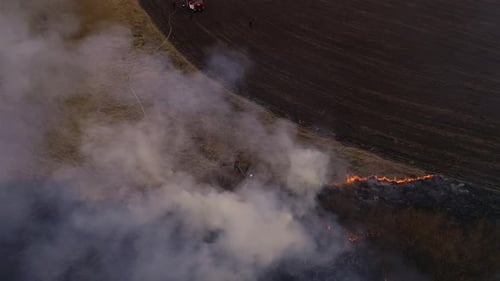 Firefighters Battling Brush Fire in Rural Field
