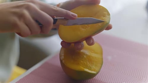 Cutting a Fresh Mango Fruit in Kitchen