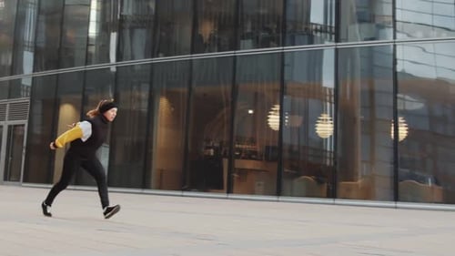 Young Adults Performing Parkour in Urban Environment