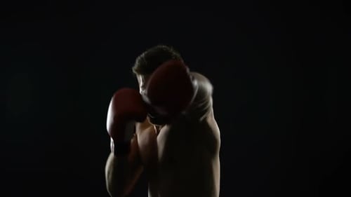 Shirtless Boxer Training, Punching in the Dark