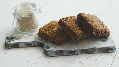 Granola Bars Stacked on Rustic Cutting Board