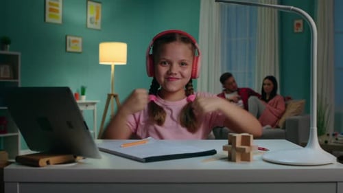 Girl Learning Sign Language at Desk with Laptop