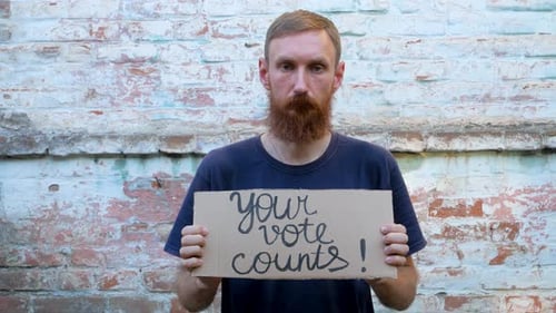 Man Holds a Sign That Your Vote Counts