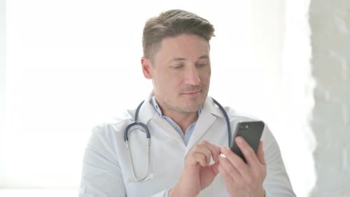 Doctor Using Smartphone in Clinic Setting
