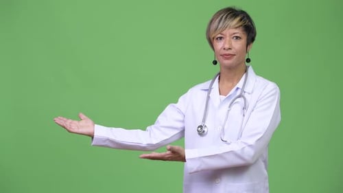 Doctor Woman Presenting on Green Background