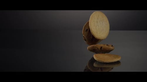 Delicious Cookies Falling onto a Shiny Surface