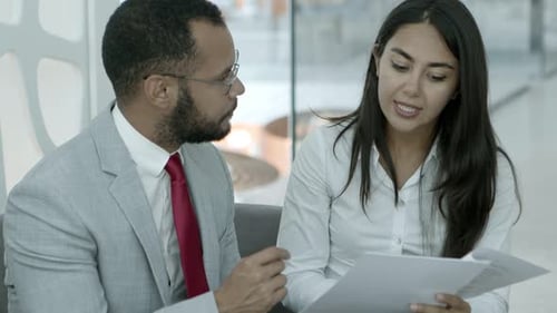 Colleagues Reviewing Documents in Modern Office