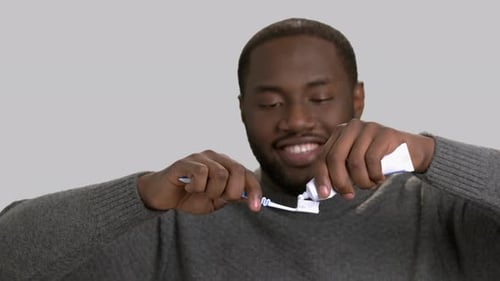 Man Applying Toothpaste on Toothbrush.