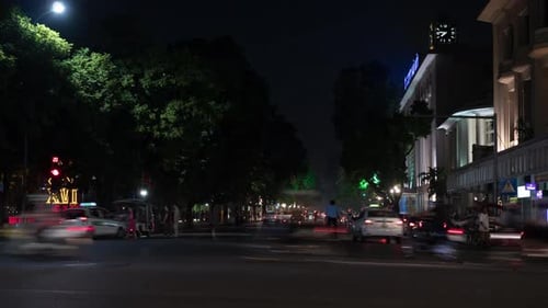Timelapse of night city, seen busy road with passing cars, motorcycles and cyclists