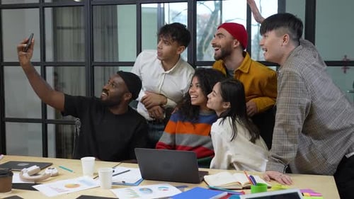 Diverse Team Takes Selfie in Modern Workplace
