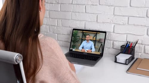Woman Video Conferencing with Man on Laptop