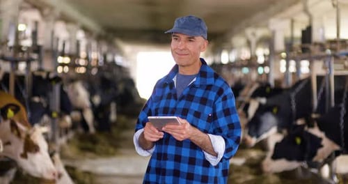 Thoughtful Mature Male Farmer Using Digital Tablet