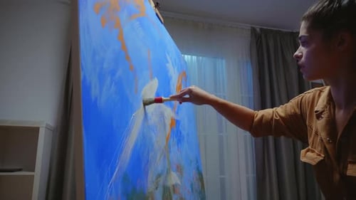 Woman Painting Large Canvas with Broad Brushstrokes