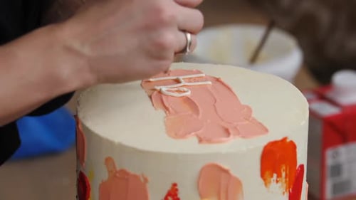 Decorating Birthday Cake with Frosting Close Up