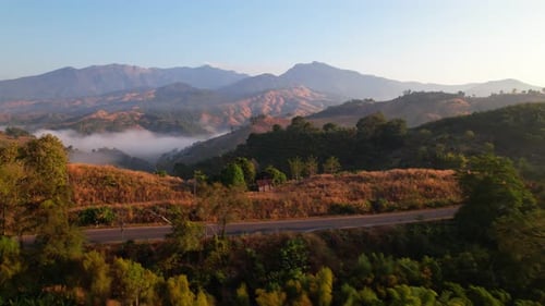 4K High mountain road in fog. Tropical forest with smoke and fog.