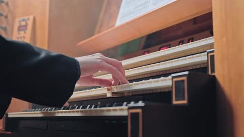 Organist Plays Music on Church Organ