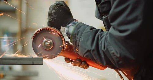 Angle Grinder Cutting Metal at Workshop