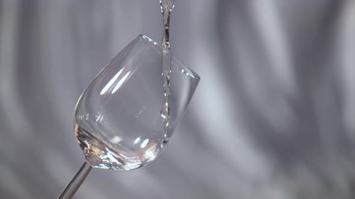 Pouring white wine in a glass