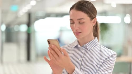 Young Woman Using Smartphone Indoors