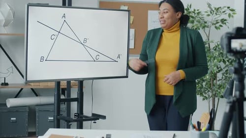 Teacher Explains Geometry Lesson to Camera