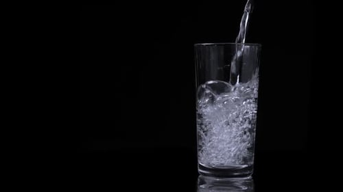 Water Being Poured into a Clear Glass