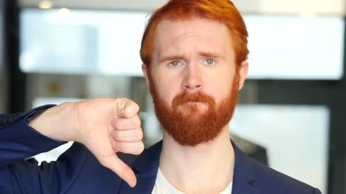 Thumbs Down by Businessman with Red Hair, Beard
