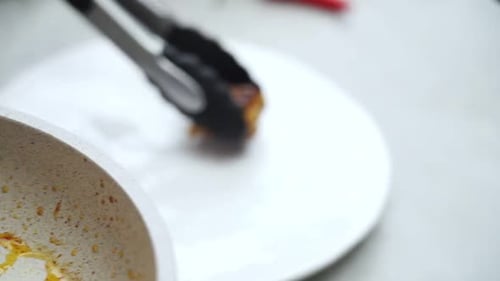Woman serving meatballs on ceramic plate