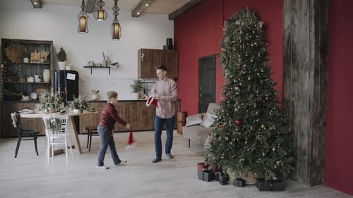 Father and Son Playfully Celebrate Christmas at Home