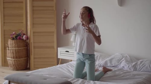 Girl Listening to Music on Headphones and Dancing